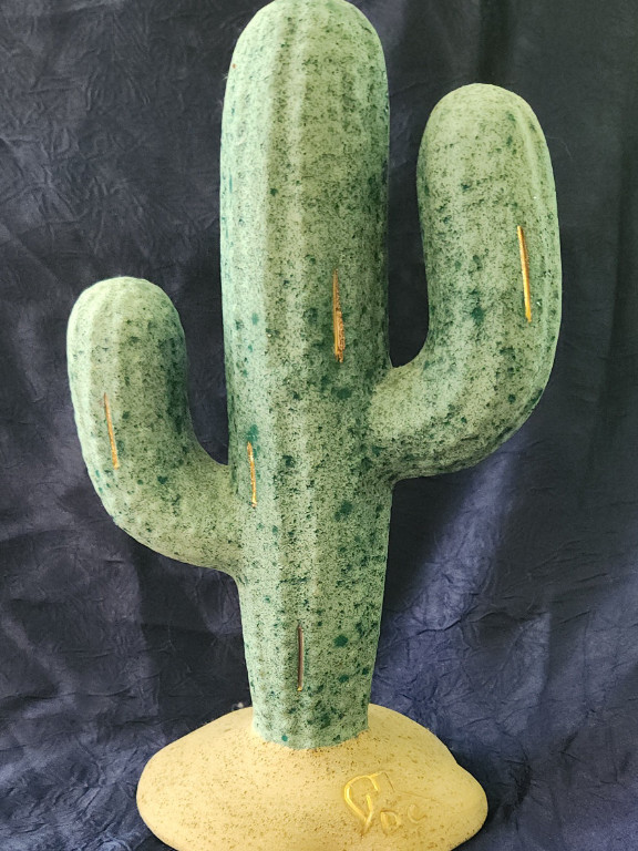 Ceramic cactus sculpture with verdigris patina finish.  'D C' artist signature with emblem of a pottery base or jug.