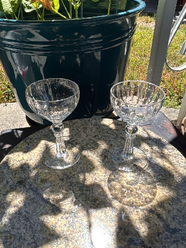Pair of vintage cut crystal champagne coupes with faceted stems