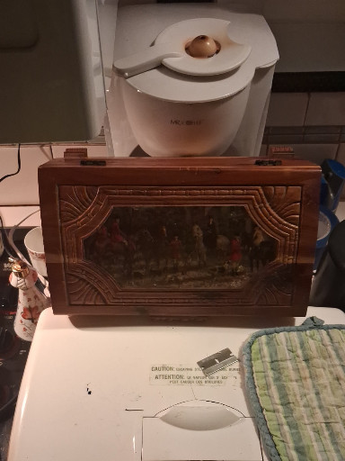 Hand-carved wooden jewelry box with hunting scene relief