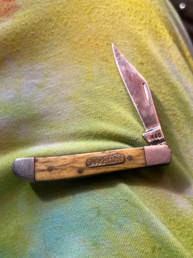 Vintage folding pocket knife with wood handle marked 'CAMILLUS'