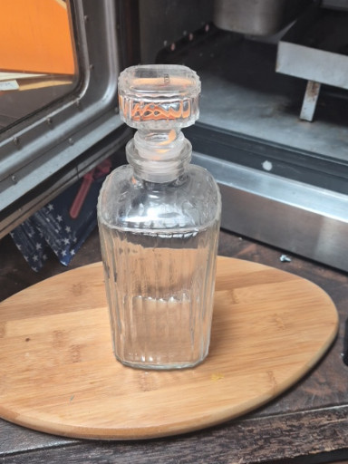 Clear pressed glass decanter with vertical ribbed pattern and stopper