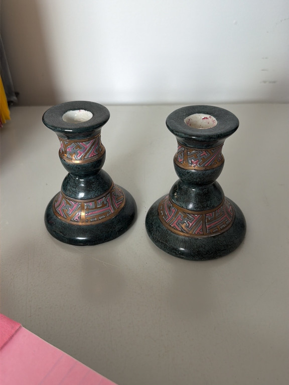 Pair of ceramic candlestick holders with black glaze and multicolored geometric banding