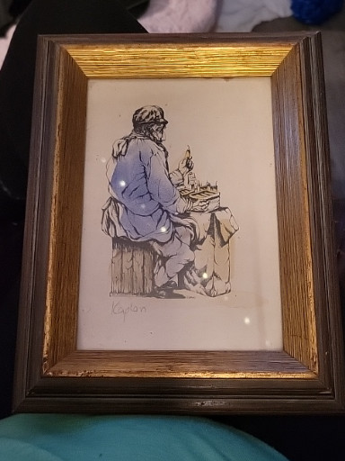 Watercolor and ink illustration depicting a seated figure with a dog, signed 'Kaplan'