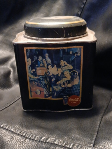 Metal collectible tin featuring 1950s-style soda fountain scene by Coca-Cola
