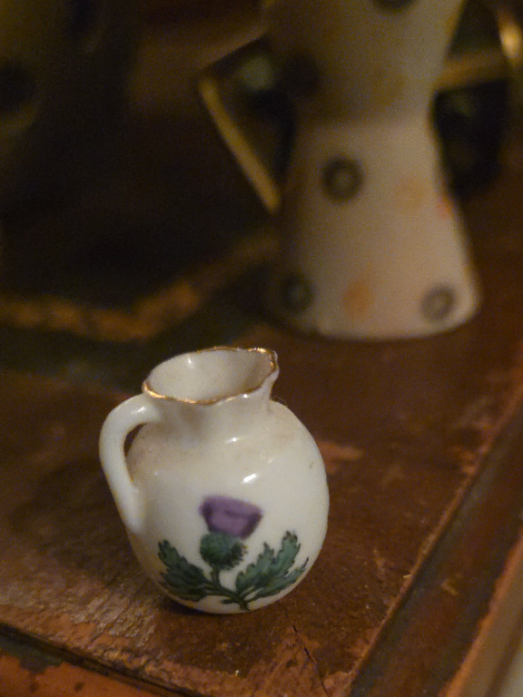 Miniature porcelain jug with Scottish thistle decoration and gold trim