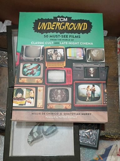Paperback book titled 'TCM Underground: 50 Must-See Films from the World of Classic Cult and Late-Night Cinema' by Millie De Chirico and Quatoyiah Murry