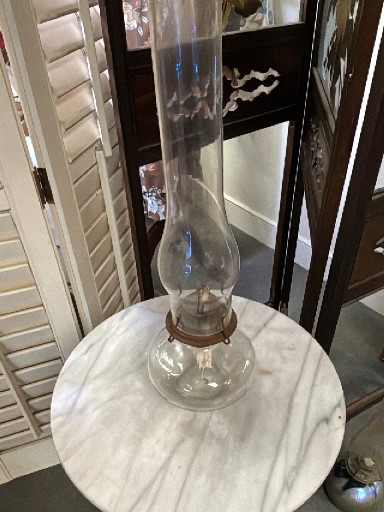 Clear glass oil lamp with tall chimney, likely Queen Anne or Victorian style