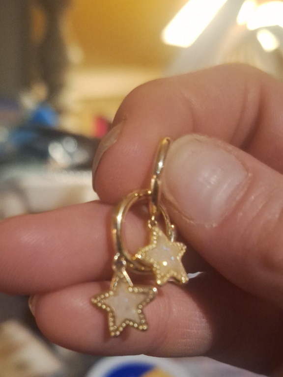 Gold-plated huggie hoop earrings with star charms by Kendra Scott