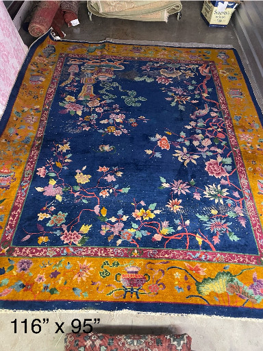 Hand-knotted wool Chinese Art Deco rug with floral motifs on navy field with golden-yellow border