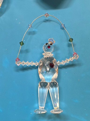 Crystal glass figurine of a clown juggling balls