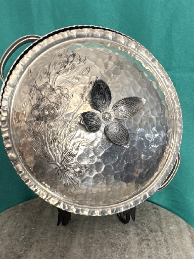 Hand-forged hammered aluminum serving dish with floral decoration