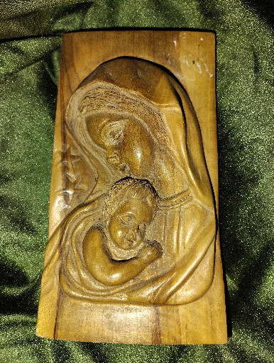 Hand-carved wooden relief plaque depicting Madonna and Child by artist Guido