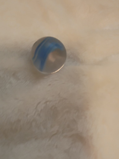 Glass marble with blue and white swirl pattern