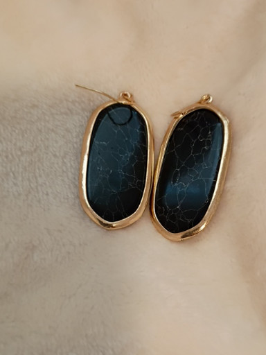 Gold-tone drop earrings with black stone cabochons