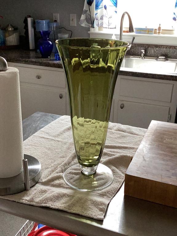 Green glass flared vase with pedestal base, likely Fostoria Coin pattern