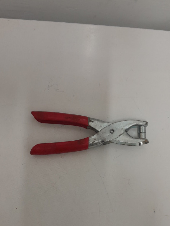 Metal snap fastener pliers with red handles