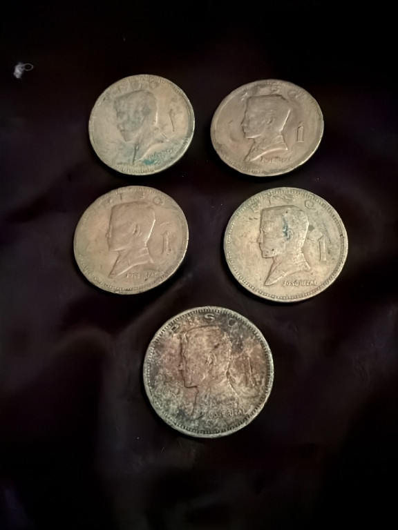 Five silver coins featuring various world currency denominations from the mid-20th century