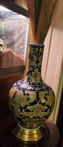 Porcelain vase with cobalt blue and gilt decoration featuring floral and scrolling foliage motifs