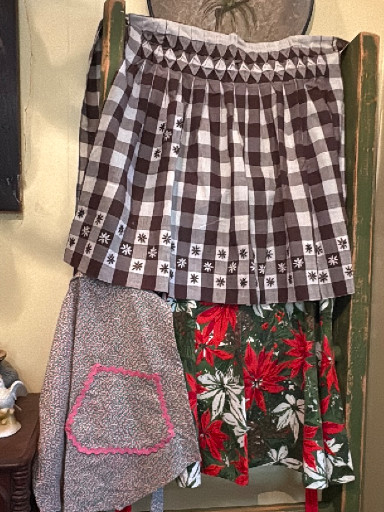 Collection of three vintage cotton skirts featuring gingham check and floral patterns