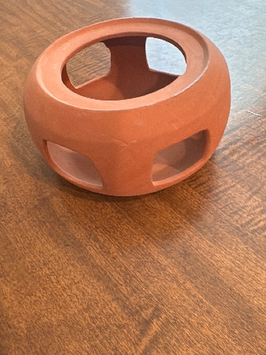 Terra cotta candle holder or incense burner with geometric cutouts