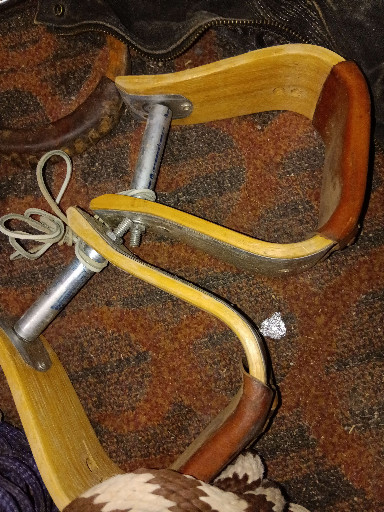 Pair of vintage wooden Western bell stirrups with metal reinforcement