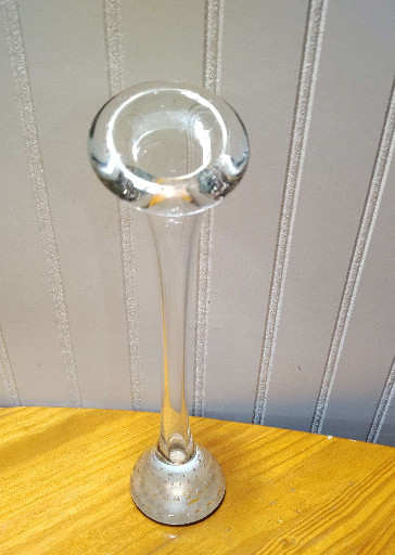 Clear glass bud vase with controlled bubble base and flared rim