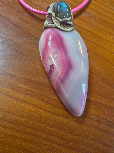 Pink agate pendant with sterling silver bail and blue topaz accent