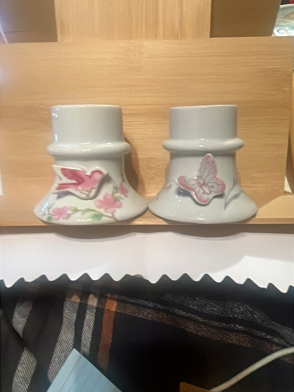 Pair of ceramic candle holders with hand-painted floral and butterfly motifs