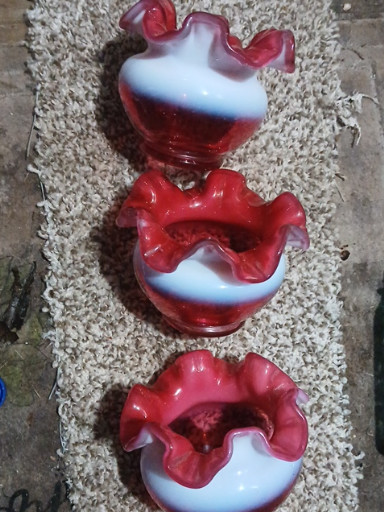 Set of three cranberry opalescent glass bowls with ruffled crimped edges