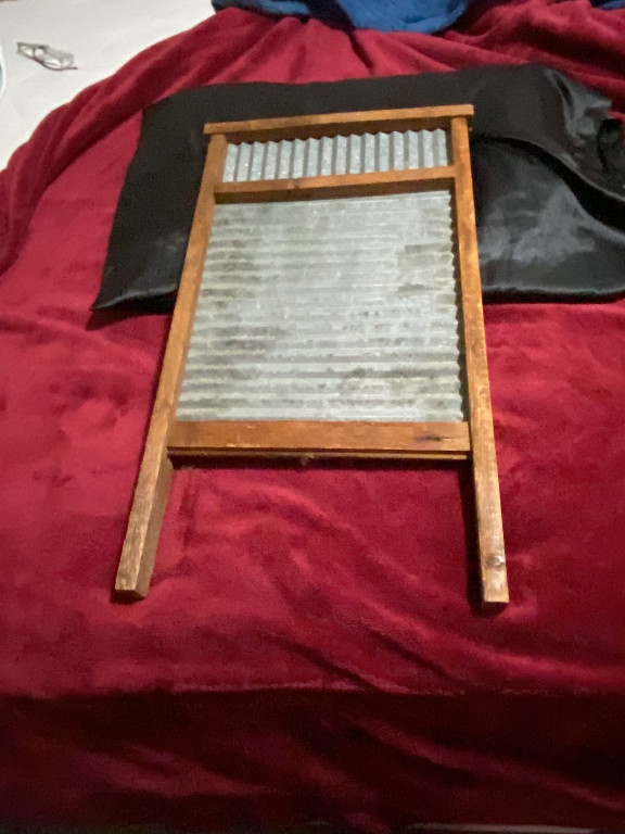 Vintage wooden washboard with metal scrubbing surface