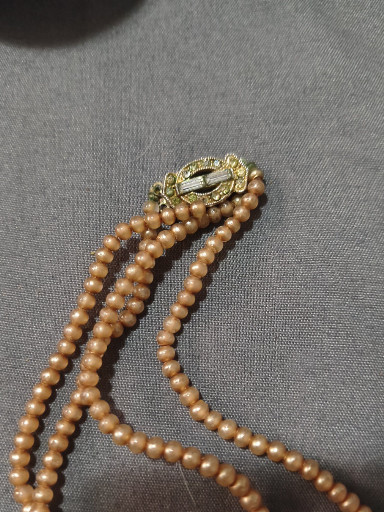 Multi-strand graduated faux pearl necklace with ornate rhinestone and pearl clasp