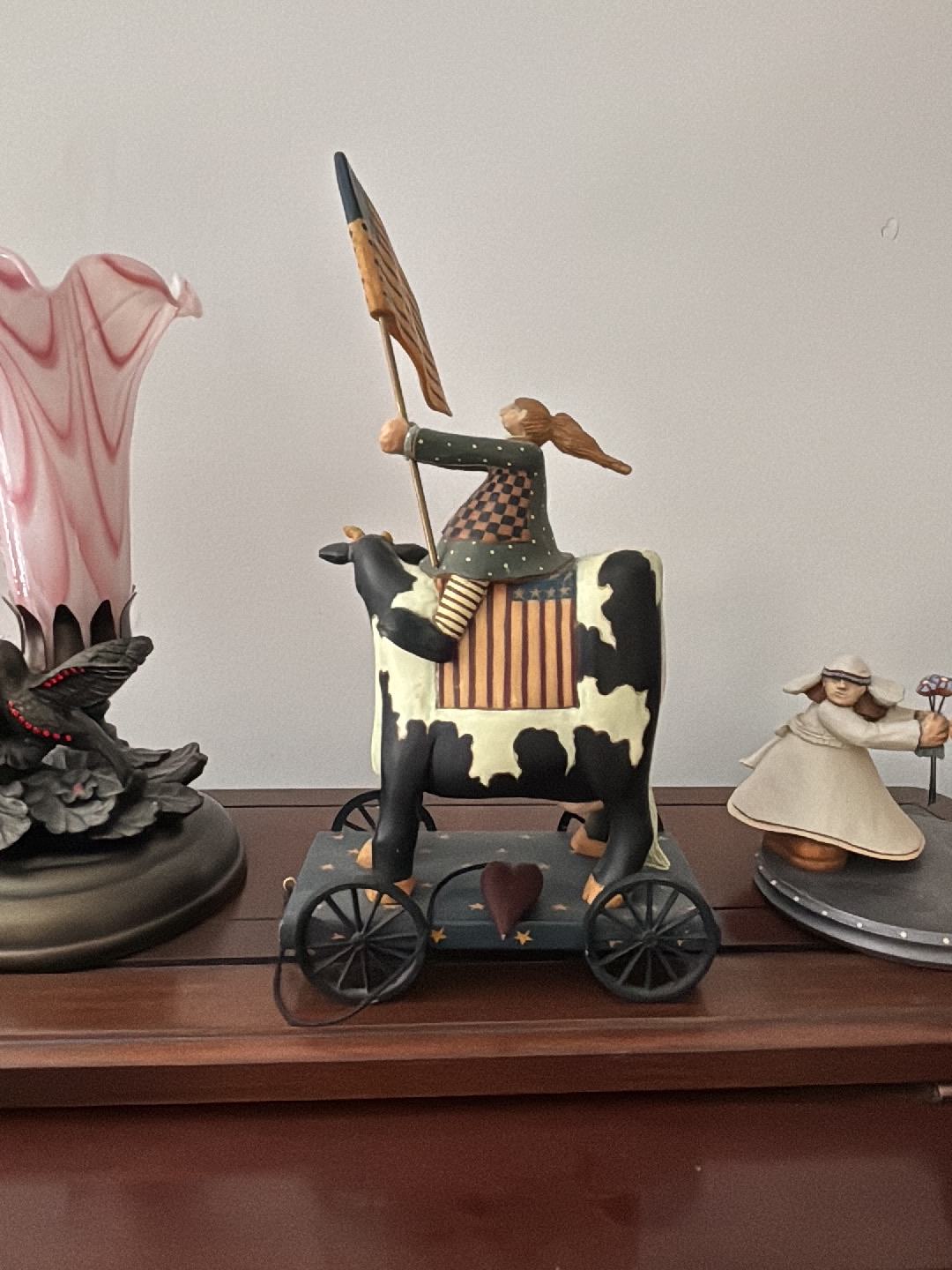 Resin folk art figurine titled 'Patriotic Girl on Cow Pull Toy' by Williraye Studios