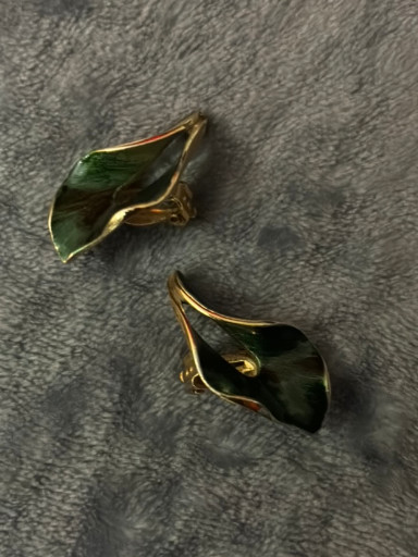 Gold-tone metal earrings with green enamel leaf design