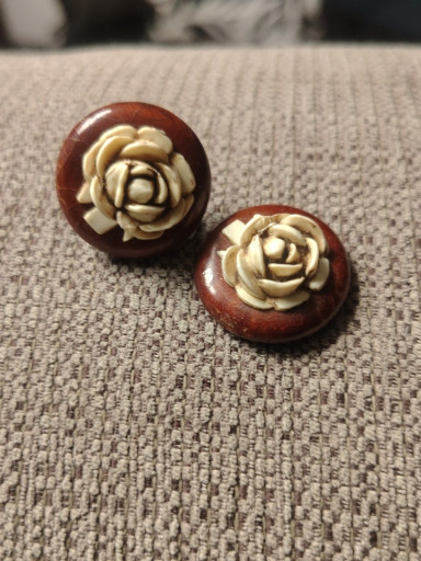 Vintage celluloid rose earrings on wood base