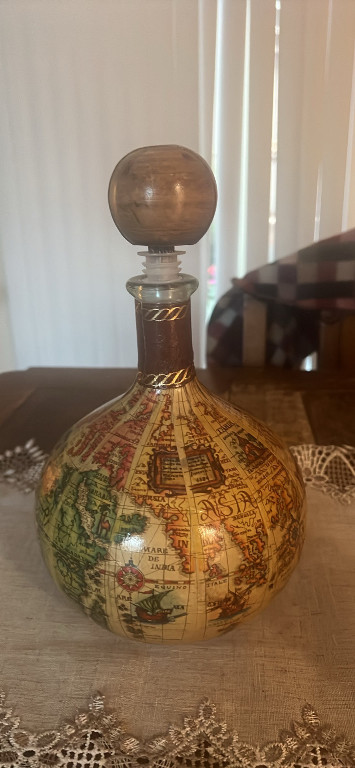 Glass decanter with leather world map wrap and wooden stopper