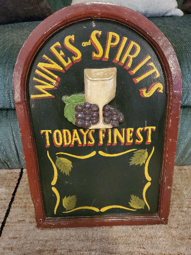 Hand-painted wooden sign titled 'Wines and Spirits Today's Finest'