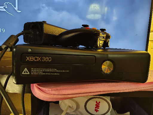 Microsoft Xbox 360 S (Slim) gaming console in black with controller and intercooler attachment