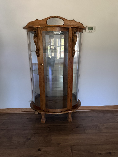 Wooden curved glass display cabinet (curio cabinet) with ornate carved details