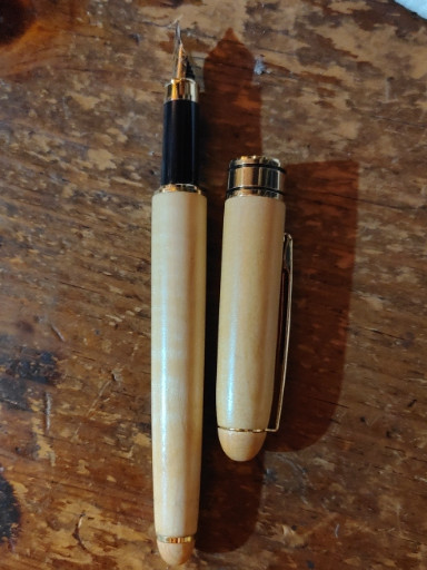 Handcrafted wooden rollerball pen with gold-plated trim