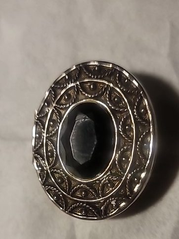 Silver-tone metal locket brooch with black onyx cabochon by Avon
