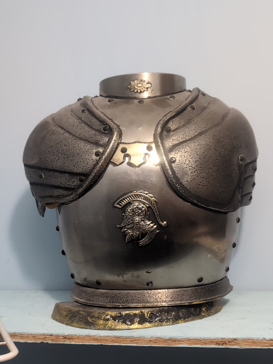 Metal decorative breastplate armor sculpture with shoulder guards and embossed eagle motif this is a decanter set with two bottles   the lids are helmets