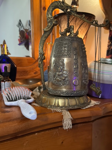 Bronze temple bell with dragon handle and Buddhist inscriptions