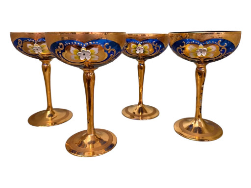Set of four Venetian Murano glass champagne coupes with cobalt blue bowls, amber glass stems, and hand-painted floral enamel decoration with 24kt gold trim