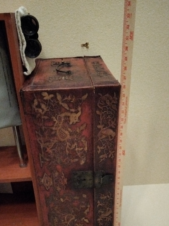 Antique Chinese red lacquered leather trunk with carved dragon motifs