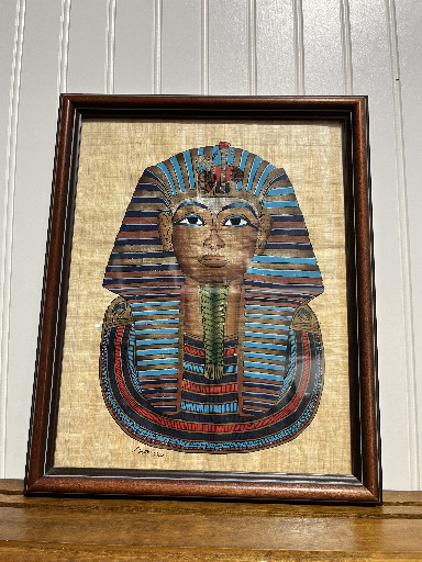 Hand-painted papyrus artwork depicting King Tutankhamun's funerary mask, framed