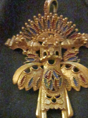 Gold-tone metal pendant titled 'Aztec Warrior' by Castlecliff