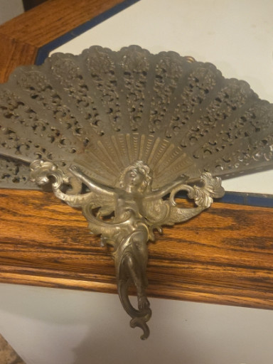 Brass Victorian-style fireplace fan screen with cherub or angel figure