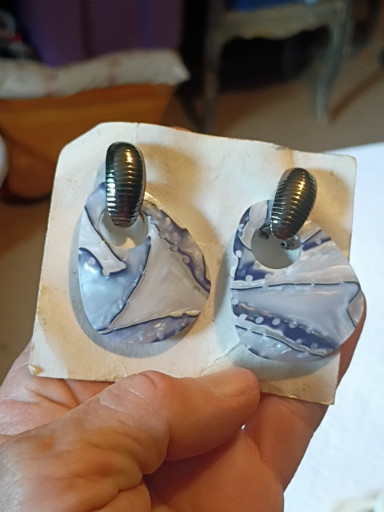 Polymer clay oval dangle earrings with marbled blue and white wave pattern