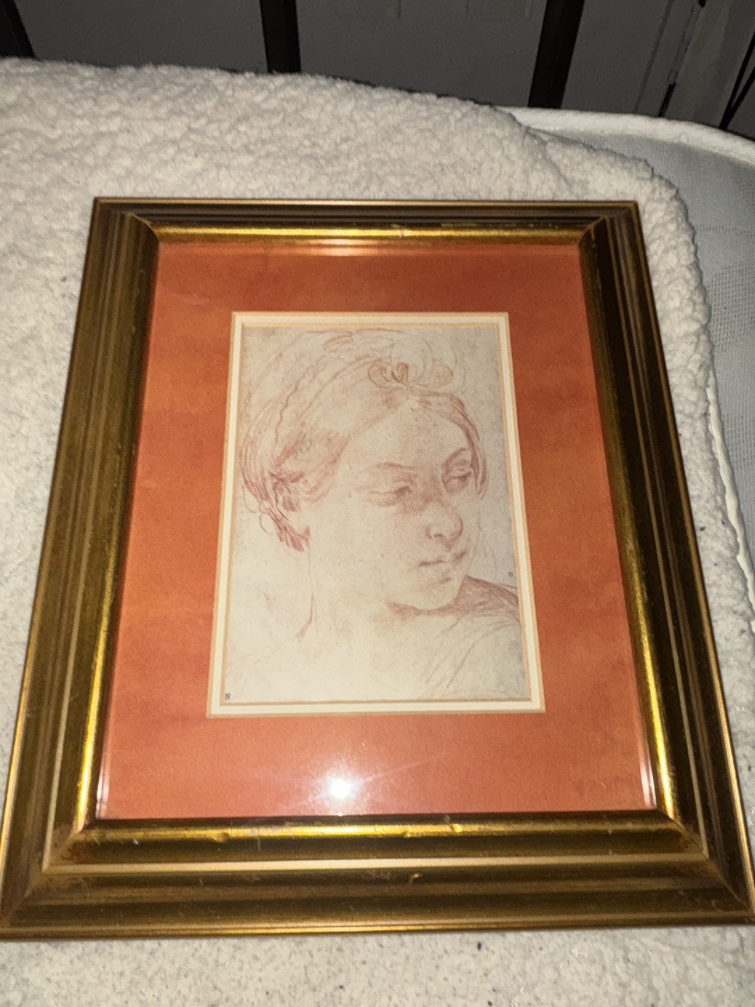 Red chalk drawing titled 'Young Woman's Head, Turned to Glance over Her Left Shoulder' by Guido Reni
