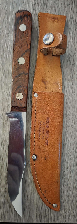 Vintage hunting knife with wooden handle and leather sheath by Puma Solingen